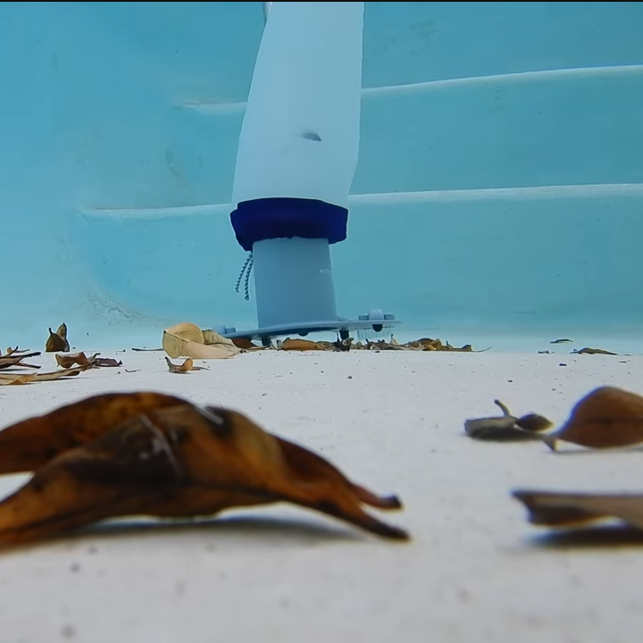 Wide underwater angle of Kokido pool vacuum with Clear Pool 45 Micron Micro Bag vacuuming debris from pool floor