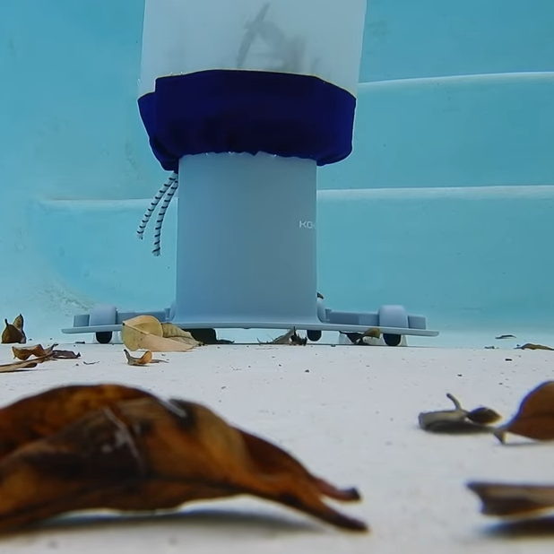 Underwater view of Kokido pool vacuum with Clear Pool 45 Micron Micro Bag operating on pool floor surrounded by leaves