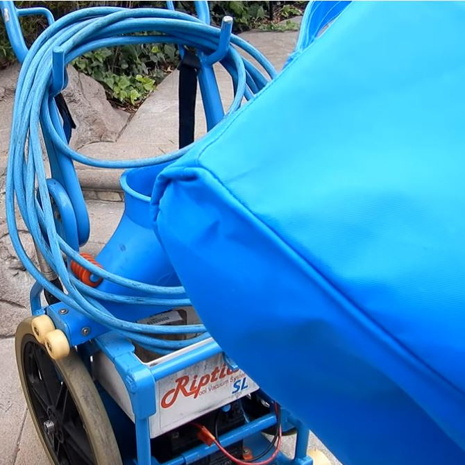 Close-up of reinforced stitching on the Riptide pool vacuum system cover showing cover being placed over unit