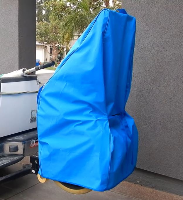 Riptide pool vacuum system cover partially installed over the unit showing fit and coverage
